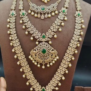 Luxury Gold Plated American Diamond (CZ) & Emerald Bridal Jewellery Combo Set with Leafy Vines (Choker, Short Necklace, Haram, Earrings & Maang Tikka)