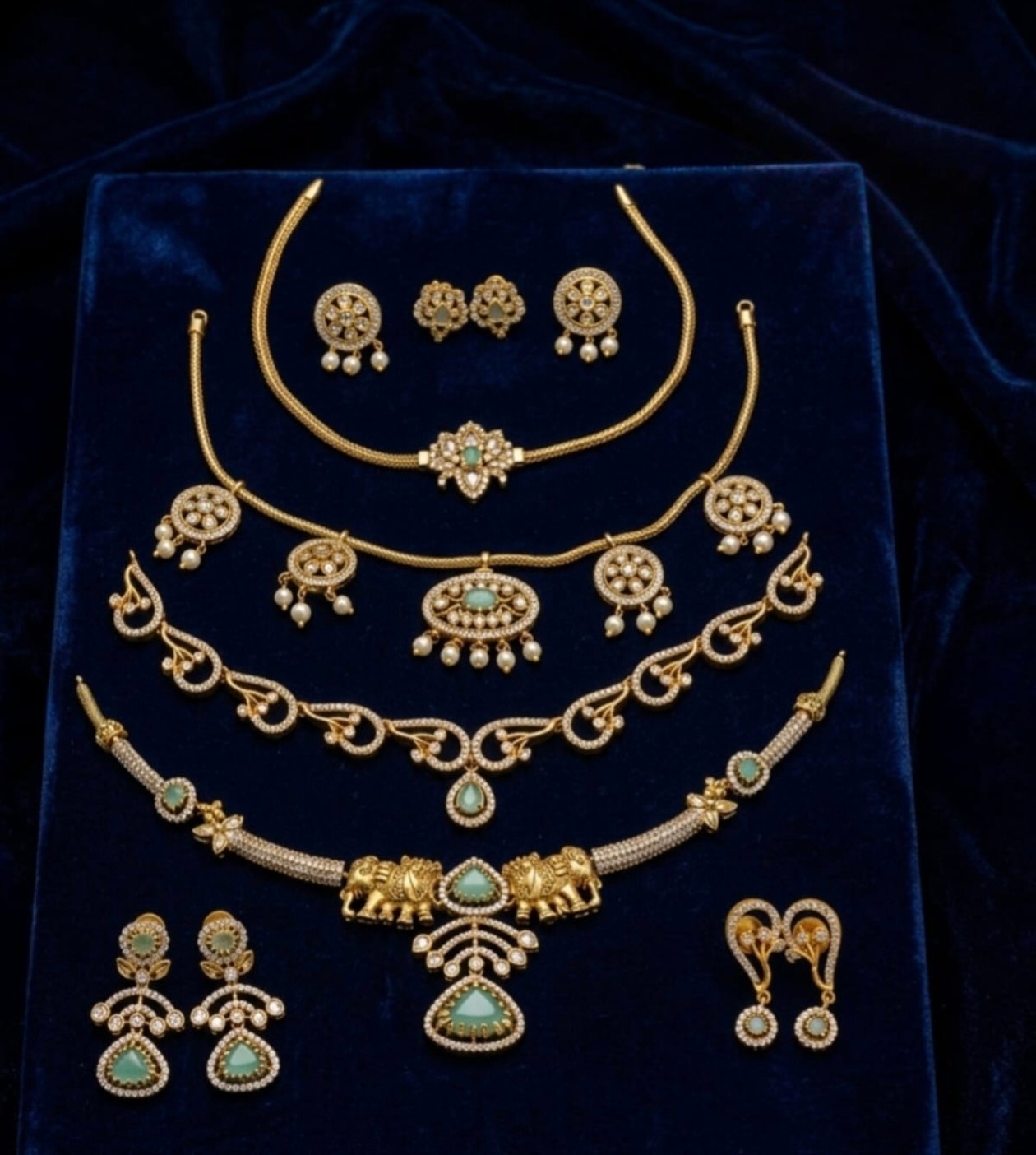 Luxury Matte Gold & Cubic Zirconia Emerald Green Bridal Jewellery Collection Set (Chokers, Necklaces, Elephant Pendant & Matching Earrings)