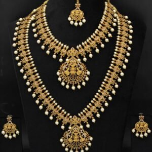 Royal Antique Gold Plated Temple Jewellery Set with Goddess Lakshmi & Pearl Detailing (Short Necklace, Haram, Earrings & Maang Tikka)